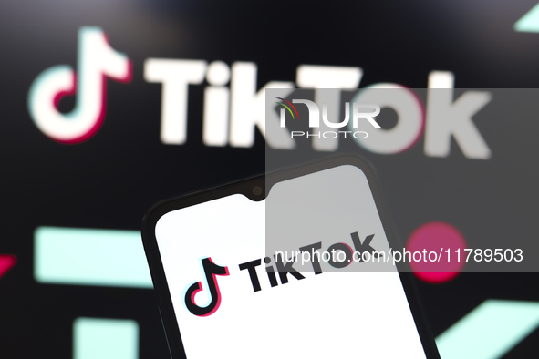 The logo of the social network TikTok appears on the screen of a smartphone and in the background on the computer in Reno, United States, on...