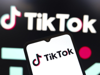 The logo of the social network TikTok appears on the screen of a smartphone and in the background on the computer in Reno, United States, on...