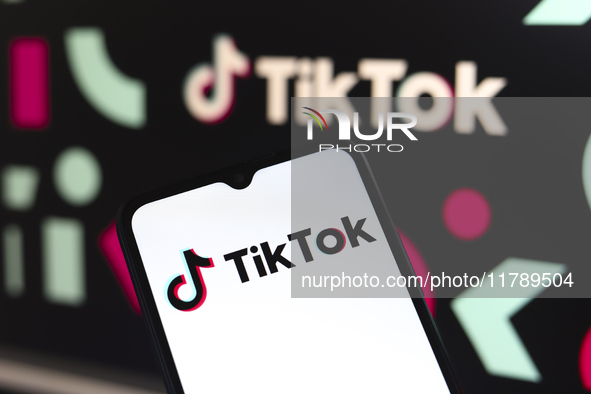 The logo of the social network TikTok appears on the screen of a smartphone and in the background on the computer in Reno, United States, on...