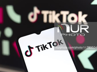 The logo of the social network TikTok appears on the screen of a smartphone and in the background on the computer in Reno, United States, on...