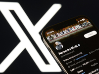 An editorial image shows an iPhone screen displaying Narendra Modi's personal account on the X social network platform. (