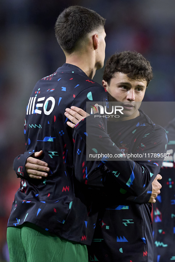 Joao Neves hugs Antonio Silva of Portugal during the warm-up prior to the UEFA Nations League 2024/25 League A Group A1 match between Portug...