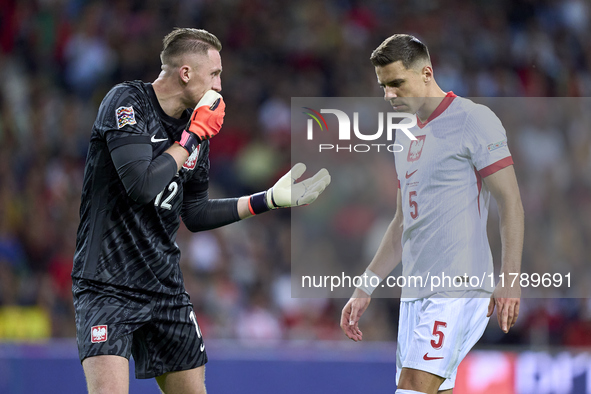 Marcin Bulka of Poland talks with Jan Bednarek of Poland during the UEFA Nations League 2024/25 League A Group A1 match between Portugal and...