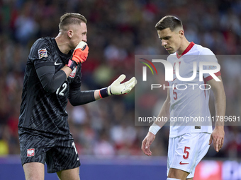 Marcin Bulka of Poland talks with Jan Bednarek of Poland during the UEFA Nations League 2024/25 League A Group A1 match between Portugal and...