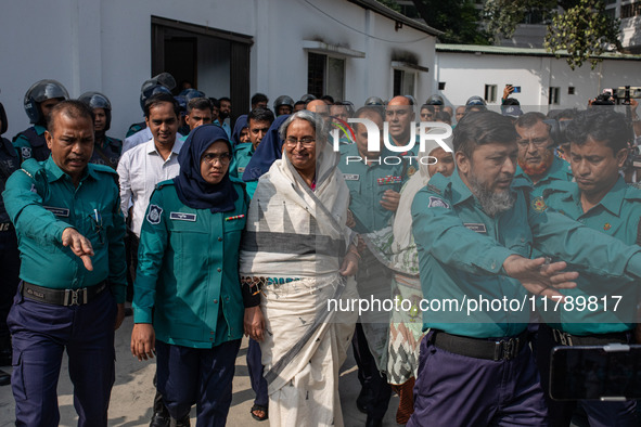 Police personnel escort detainee Dipu Moni, a former minister of Bangladesh's ousted government led by the Bangladesh Awami League, to the I...