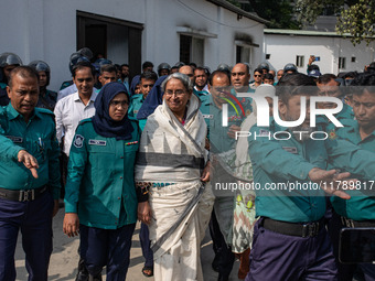 Police personnel escort detainee Dipu Moni, a former minister of Bangladesh's ousted government led by the Bangladesh Awami League, to the I...