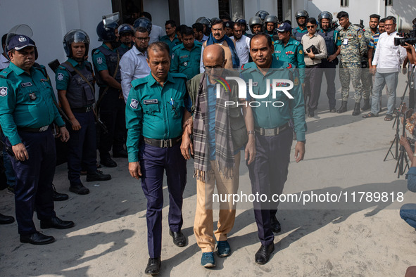 Police personnel escort detainee Tawfiq-e-Elahi Chowdhury, former energy adviser to the ousted Prime Minister of Bangladesh Sheikh Hasina, t...