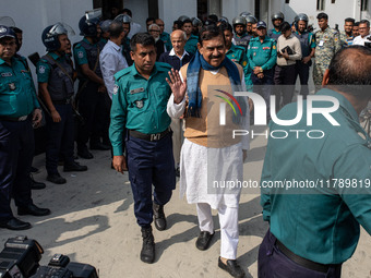 Police personnel escort detainee Shajahan Khan, a former Member of Parliament of Bangladesh's ousted government led by the Bangladesh Awami...