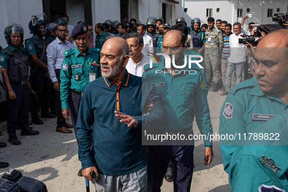 Police personnel escort detainee Faruk Khan, former Minister of Civil Aviation and Tourism of Bangladesh's ousted government led by Banglade...