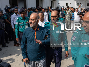 Police personnel escort detainee Faruk Khan, former Minister of Civil Aviation and Tourism of Bangladesh's ousted government led by Banglade...