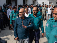 Police personnel escort detainee Faruk Khan, former Minister of Civil Aviation and Tourism of Bangladesh's ousted government led by Banglade...