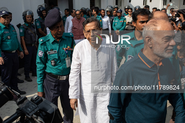 Police personnel escort detainee Anisul Haque, former law minister of Bangladesh's ousted government led by Bangladesh Awami League, to the...