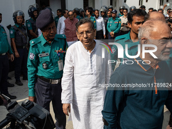 Police personnel escort detainee Anisul Haque, former law minister of Bangladesh's ousted government led by Bangladesh Awami League, to the...