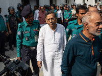 Police personnel escort detainee Anisul Haque, former law minister of Bangladesh's ousted government led by Bangladesh Awami League, to the...