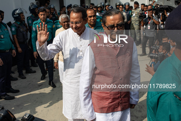 Police personnel escort detainees Hasanul Haque Inu and Rashed Khan Menon, both former members of parliament and former ministers of Banglad...