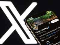 Editorial image shows an iPhone screen with Greta Thunberg's personal account displayed on the X social network platform. (