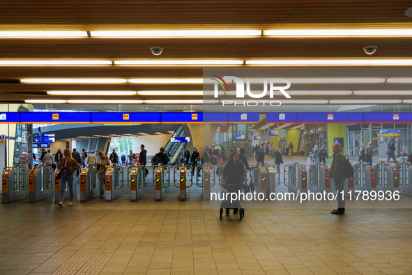 The entrance to the platforms at Arnhem Centraal Station in Arnhem, Netherlands, on July 27, 2023, shows a dynamic travel hub. Passengers pa...