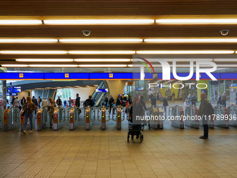 The entrance to the platforms at Arnhem Centraal Station in Arnhem, Netherlands, on July 27, 2023, shows a dynamic travel hub. Passengers pa...