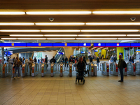 The entrance to the platforms at Arnhem Centraal Station in Arnhem, Netherlands, on July 27, 2023, shows a dynamic travel hub. Passengers pa...