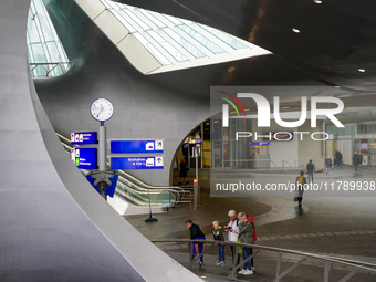 People are in the entrance hall of Arnhem Centraal station in Arnhem, The Netherlands, on July 27, 2023. The station's futuristic design, wi...