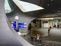 People are in the entrance hall of Arnhem Centraal station in Arnhem, The Netherlands, on July 27, 2023. The station's futuristic design, wi...