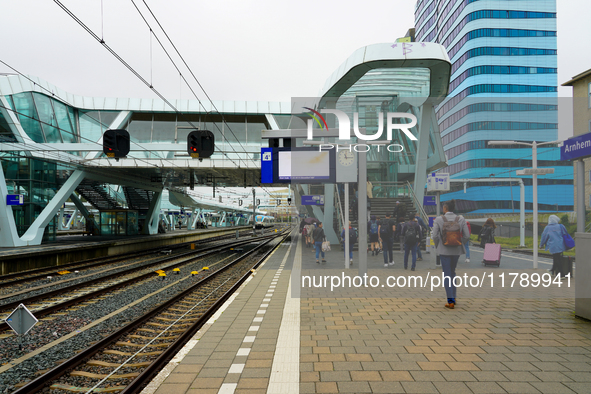 Travelers and commuters walk along Platform 4 at Arnhem Centraal Station in the Netherlands on July 27, 2023. The station's modern architect...