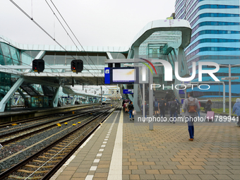 Travelers and commuters walk along Platform 4 at Arnhem Centraal Station in the Netherlands on July 27, 2023. The station's modern architect...