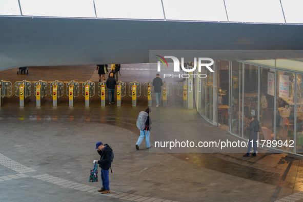 The spacious entrance hall of Arnhem Centraal Station in the Netherlands, on July 27, 2023, features several travelers passing through the a...