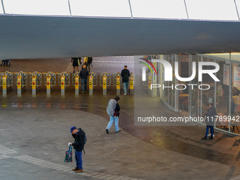 The spacious entrance hall of Arnhem Centraal Station in the Netherlands, on July 27, 2023, features several travelers passing through the a...