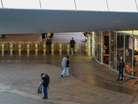 The spacious entrance hall of Arnhem Centraal Station in the Netherlands, on July 27, 2023, features several travelers passing through the a...