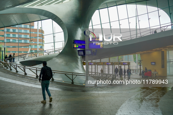 People are in the entrance hall of Arnhem Centraal station in Arnhem, The Netherlands, on July 27, 2023. The station's futuristic design, wi...