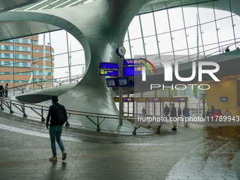 People are in the entrance hall of Arnhem Centraal station in Arnhem, The Netherlands, on July 27, 2023. The station's futuristic design, wi...