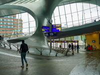 People are in the entrance hall of Arnhem Centraal station in Arnhem, The Netherlands, on July 27, 2023. The station's futuristic design, wi...