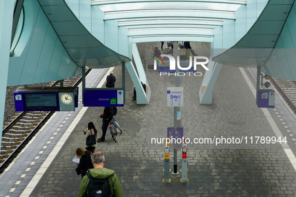 A view of Platform 7 at Arnhem Centraal Station in Arnhem, Netherlands, on July 27, 2023, shows passengers waiting under the sleek modern ca...