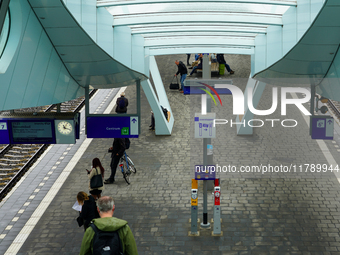 A view of Platform 7 at Arnhem Centraal Station in Arnhem, Netherlands, on July 27, 2023, shows passengers waiting under the sleek modern ca...