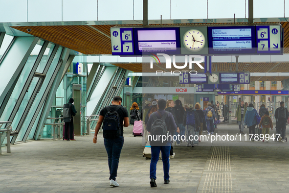 A bustling scene occurs at Arnhem Centraal Station in Arnhem, Netherlands, on July 27, 2023. Passengers move along the station's modern conc...