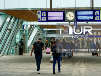 A bustling scene occurs at Arnhem Centraal Station in Arnhem, Netherlands, on July 27, 2023. Passengers move along the station's modern conc...