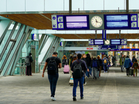 A bustling scene occurs at Arnhem Centraal Station in Arnhem, Netherlands, on July 27, 2023. Passengers move along the station's modern conc...