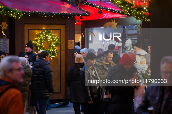 Visitors check the stalls selling Christmas decorations at Cologne Christmas in front of Dam Cathedral in Cologne, Germany, on November 18,...