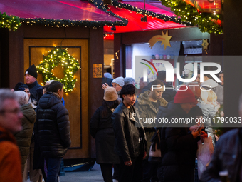 Visitors check the stalls selling Christmas decorations at Cologne Christmas in front of Dam Cathedral in Cologne, Germany, on November 18,...