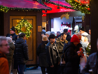 Visitors check the stalls selling Christmas decorations at Cologne Christmas in front of Dam Cathedral in Cologne, Germany, on November 18,...