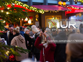 Visitors check the stalls selling Christmas decorations at Cologne Christmas in front of Dam Cathedral in Cologne, Germany, on November 18,...