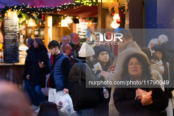 Visitors check the stalls selling Christmas decorations at Cologne Christmas in front of Dam Cathedral in Cologne, Germany, on November 18,...