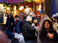 Visitors check the stalls selling Christmas decorations at Cologne Christmas in front of Dam Cathedral in Cologne, Germany, on November 18,...