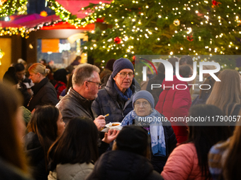 Visitors check the stalls selling Christmas decorations at Cologne Christmas in front of Dam Cathedral in Cologne, Germany, on November 18,...