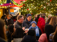 Visitors check the stalls selling Christmas decorations at Cologne Christmas in front of Dam Cathedral in Cologne, Germany, on November 18,...