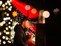 Visitors check the stalls selling Christmas decorations at Cologne Christmas in front of Dam Cathedral in Cologne, Germany, on November 18,...