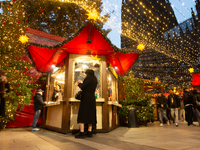 Visitors check the stalls selling Christmas decorations at Cologne Christmas in front of Dam Cathedral in Cologne, Germany, on November 18,...