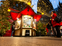 Visitors check the stalls selling Christmas decorations at Cologne Christmas in front of Dam Cathedral in Cologne, Germany, on November 18,...