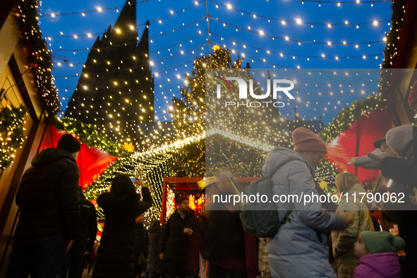 Visitors check the stalls selling Christmas decorations at Cologne Christmas in front of Dam Cathedral in Cologne, Germany, on November 18,...